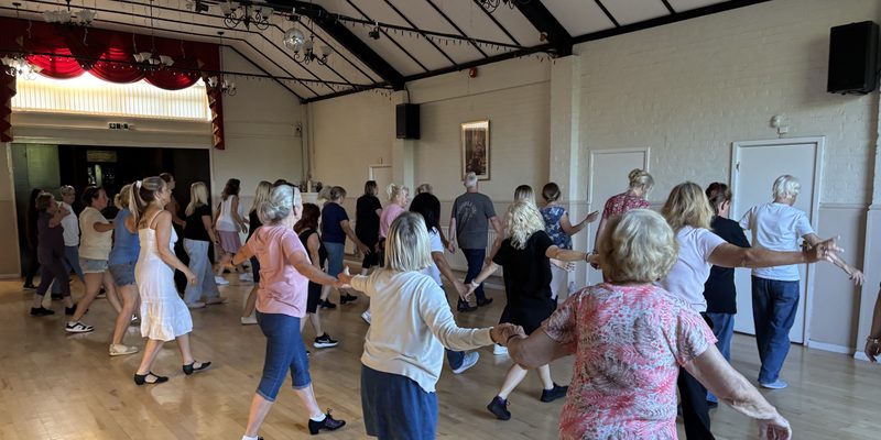 An improver line dancing class in the Main Hall