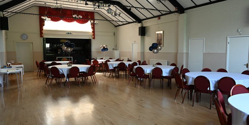 The Main Hall set with round tables and red chairs