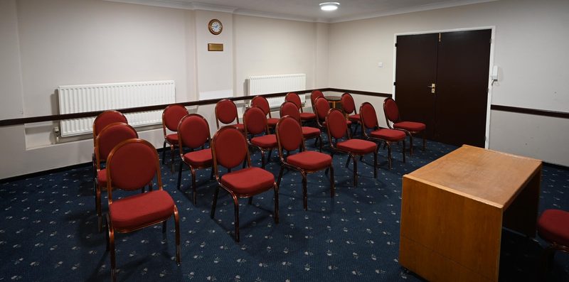 The Shirley Room arranged with chairs and a lectern